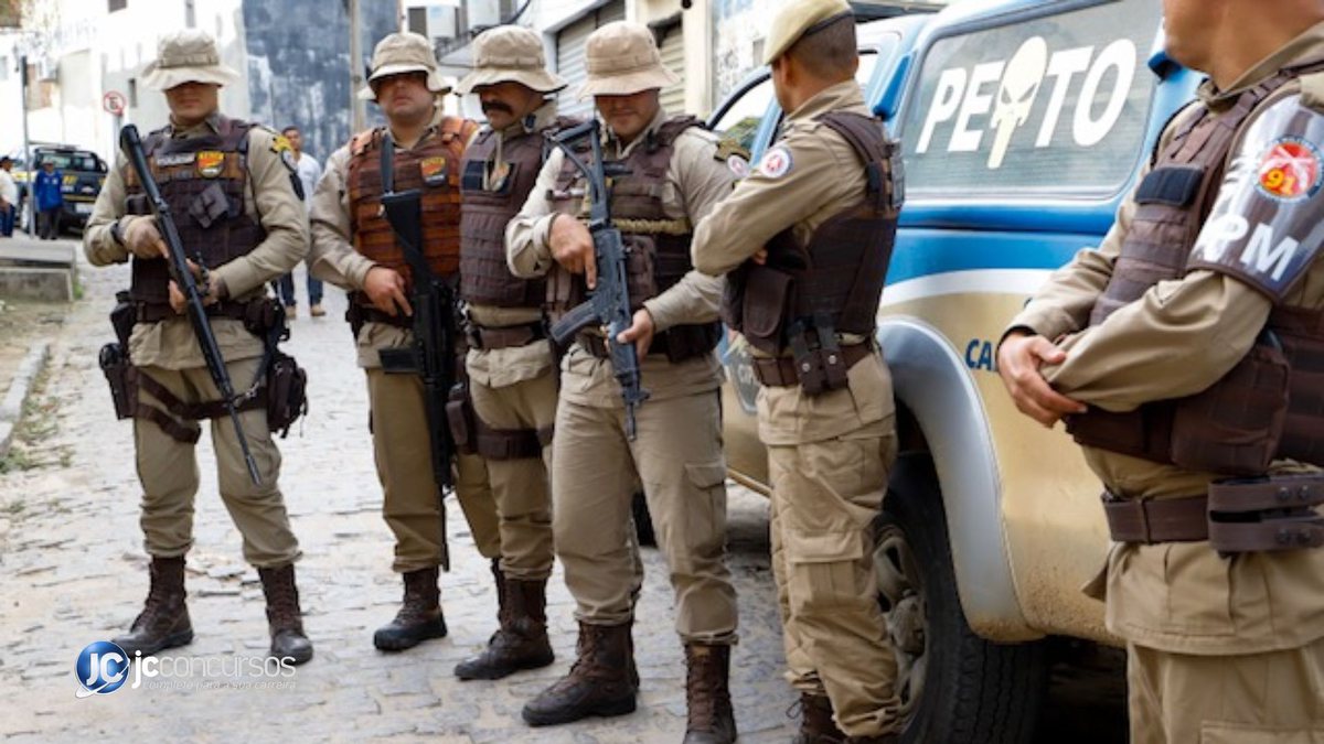 Soldados da Polícia Militar da Bahia perfilados ao lado de viatura