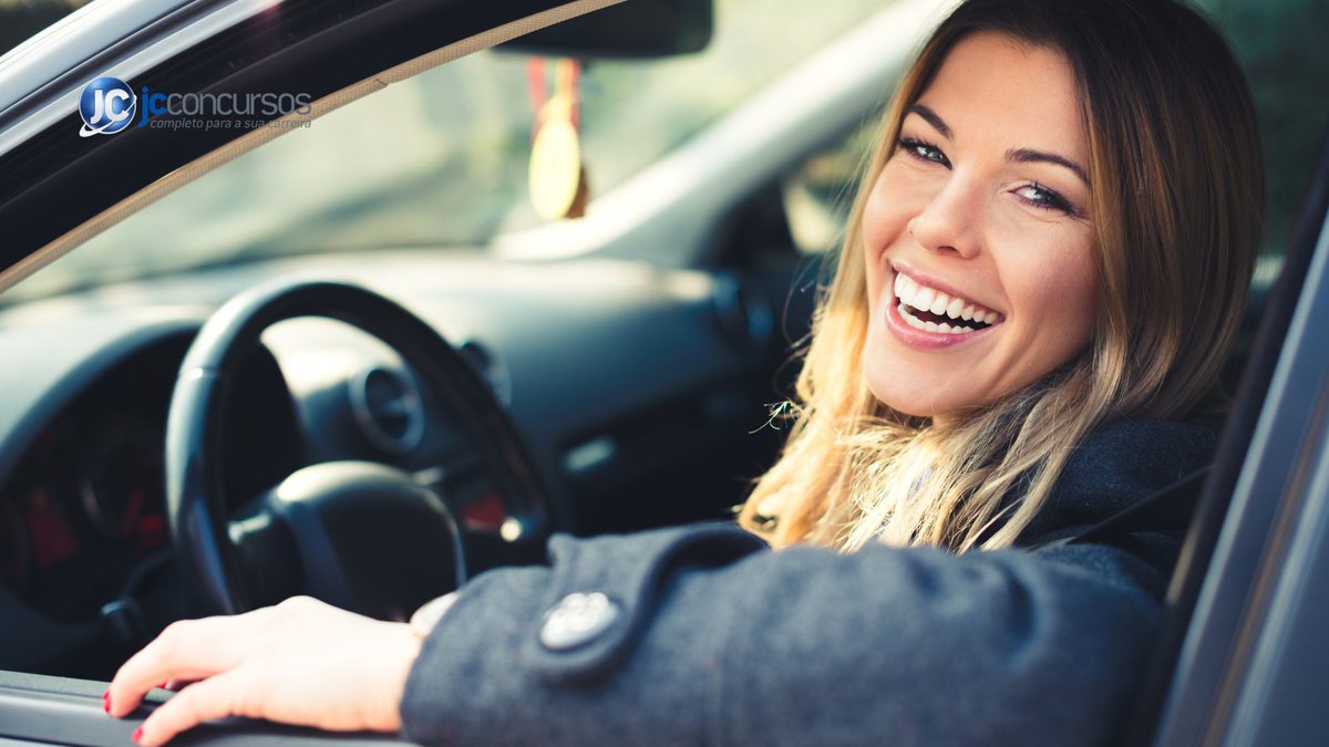 Motorista mulher sorri ao volante de carro - Divulgação